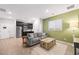 Inviting living area connected to the kitchen, featuring a comfortable sofa and a modern decor at 7073 Range Valley St, North Las Vegas, NV 89084