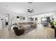 Spacious living room with tile floors, a large sectional sofa, ceiling fan, and an open floor plan at 7073 Range Valley St, North Las Vegas, NV 89084