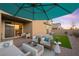 Covered patio with comfortable seating area and artificial grass at 7073 Range Valley St, North Las Vegas, NV 89084