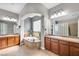 Serene bathroom with dual vanities, a soaking tub, and natural light from glass block window at 7288 Olsen Farm St, Las Vegas, NV 89131