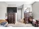 Cozy bedroom featuring dark wood dressers with carpet flooring, a rattan chair, and neutral paint at 7288 Olsen Farm St, Las Vegas, NV 89131