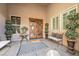 Charming entryway with a cozy bench, potted plants, and a beautiful decorative rug at 7288 Olsen Farm St, Las Vegas, NV 89131