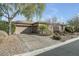 Attractive single-story home featuring a desert landscape, a well-maintained driveway, and an attached garage at 7288 Olsen Farm St, Las Vegas, NV 89131