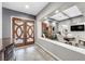 Elegant entryway with a wooden front door leading to a dining area with stylish decor at 7288 Olsen Farm St, Las Vegas, NV 89131