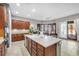 Kitchen with stone countertops, tile floors, and sliding door to backyard at 7288 Olsen Farm St, Las Vegas, NV 89131