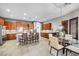 Spacious eat-in kitchen with warm wood cabinets, stainless appliances, and modern lighting at 7288 Olsen Farm St, Las Vegas, NV 89131