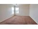 Bright bedroom with neutral carpet and large windows at 7732 Prosperity River Ave, Las Vegas, NV 89129