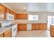 Spacious kitchen featuring wood cabinets, and modern appliances at 7732 Prosperity River Ave, Las Vegas, NV 89129