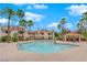 Community pool with patio and palm trees at 7900 Idledale Ct # 102, Las Vegas, NV 89145