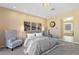 Spacious main bedroom with carpet, a decorative clock, and arched entryway to the main bathroom at 8320 Carmel Ridge Ct, Las Vegas, NV 89113