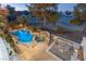 Stunning aerial view of the pool and spa with a waterfall feature, surrounded by a patio and lush landscaping at 8320 Carmel Ridge Ct, Las Vegas, NV 89113