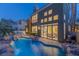 Luxury pool and spa with waterfall feature at dusk at 8320 Carmel Ridge Ct, Las Vegas, NV 89113