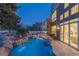 Inviting pool with a rock waterfall feature and meticulously landscaped surroundings, perfect for outdoor relaxation and entertainment at 8320 Carmel Ridge Ct, Las Vegas, NV 89113