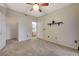 Well-lit bedroom with ceiling fan, access to bathroom and closet at 8555 W Russell Rd # 1101, Las Vegas, NV 89113