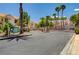 Gated community entrance with palm trees and lush landscaping at 8555 W Russell Rd # 1101, Las Vegas, NV 89113