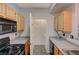 Kitchen with access to laundry, featuring light wood cabinets and granite countertops at 8555 W Russell Rd # 1101, Las Vegas, NV 89113