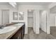 Double vanity bathroom with linen closet and toilet at 8960 Fox Season Ave, Las Vegas, NV 89178