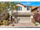 Two-story house with a two-car garage and landscaped front yard at 8960 Fox Season Ave, Las Vegas, NV 89178