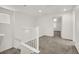 Upstairs hallway with white railing and carpet at 8960 Fox Season Ave, Las Vegas, NV 89178