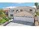 Two-story house featuring a three-car garage and well-manicured lawn at 9123 Claretta Dr, Las Vegas, NV 89129