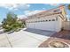 Two-story house with a three-car garage and landscaping at 9123 Claretta Dr, Las Vegas, NV 89129