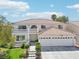 Two-story house with a three-car garage and landscaped yard at 9123 Claretta Dr, Las Vegas, NV 89129