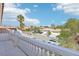 Balcony view of a residential street with houses and palm trees at 9123 Claretta Dr, Las Vegas, NV 89129