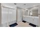 Bathroom with double vanity, white cabinets, and a shower with curtain at 9289 Casa Sierra Ln, Las Vegas, NV 89148