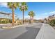 Gated community entrance with palm trees and signage at 9289 Casa Sierra Ln, Las Vegas, NV 89148