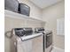 Laundry room with LG washer and dryer, and shelving for storage at 9289 Casa Sierra Ln, Las Vegas, NV 89148