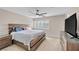 Main bedroom with king-size bed, ceiling fan, and window with shutters at 9289 Casa Sierra Ln, Las Vegas, NV 89148