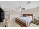 Main bedroom with king-size bed, ceiling fan, and TV at 9289 Casa Sierra Ln, Las Vegas, NV 89148