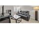 Home office featuring a black leather recliner, glass coffee table, and built-in shelving at 9289 Casa Sierra Ln, Las Vegas, NV 89148