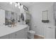 Modern bathroom with gray vanity, marble countertop, and gold fixtures at 10009 Delicate Dew St, Las Vegas, NV 89183