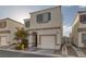 Two-story house with attached garage and landscaping at 10009 Delicate Dew St, Las Vegas, NV 89183