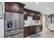 Kitchen boasts stainless steel appliances and dark wood cabinets at 10009 Delicate Dew St, Las Vegas, NV 89183