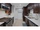 Modern kitchen with dark cabinetry and stainless steel appliances at 10009 Delicate Dew St, Las Vegas, NV 89183