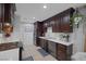 Modern kitchen with dark cabinetry and stainless steel appliances at 10009 Delicate Dew St, Las Vegas, NV 89183