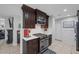 Modern kitchen with dark cabinetry and stainless steel appliances at 10009 Delicate Dew St, Las Vegas, NV 89183