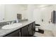 Bathroom with tub, shower, dark vanity, and granite countertop at 1004 Huckburn Ave, Henderson, NV 89015