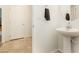 Small bathroom with pedestal sink and tiled floor at 1004 Huckburn Ave, Henderson, NV 89015