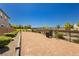 Fenced dog park with gravel surface, bench, and trash can at 1004 Huckburn Ave, Henderson, NV 89015