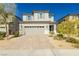 Two-story home with gray siding, gray shutters, and a paved driveway at 1004 Huckburn Ave, Henderson, NV 89015