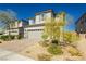 Two-story house with gray siding, gray shutters, and landscaping at 1004 Huckburn Ave, Henderson, NV 89015