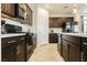 Modern kitchen with dark cabinets, stainless steel appliances, and ample counter space at 1004 Huckburn Ave, Henderson, NV 89015