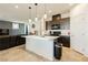 Modern kitchen with island, dark cabinetry, and stainless steel appliances at 1004 Huckburn Ave, Henderson, NV 89015