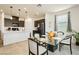 Kitchen with an island, dark cabinets, and glass table at 1004 Huckburn Ave, Henderson, NV 89015