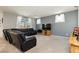 Spacious living room with leather sectional sofa and large TV at 1004 Huckburn Ave, Henderson, NV 89015