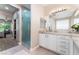 Elegant bathroom features a large vanity, walk-in shower, and access to the bedroom at 10452 Acclamato Ave, Las Vegas, NV 89135