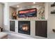 Modern fireplace with stone surround and built-in shelving at 10452 Acclamato Ave, Las Vegas, NV 89135